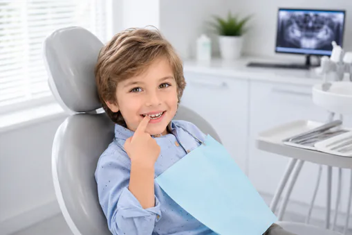 young-boy-at-dental-office-pointing-to-tooth young boy at dental office pointing to tooth